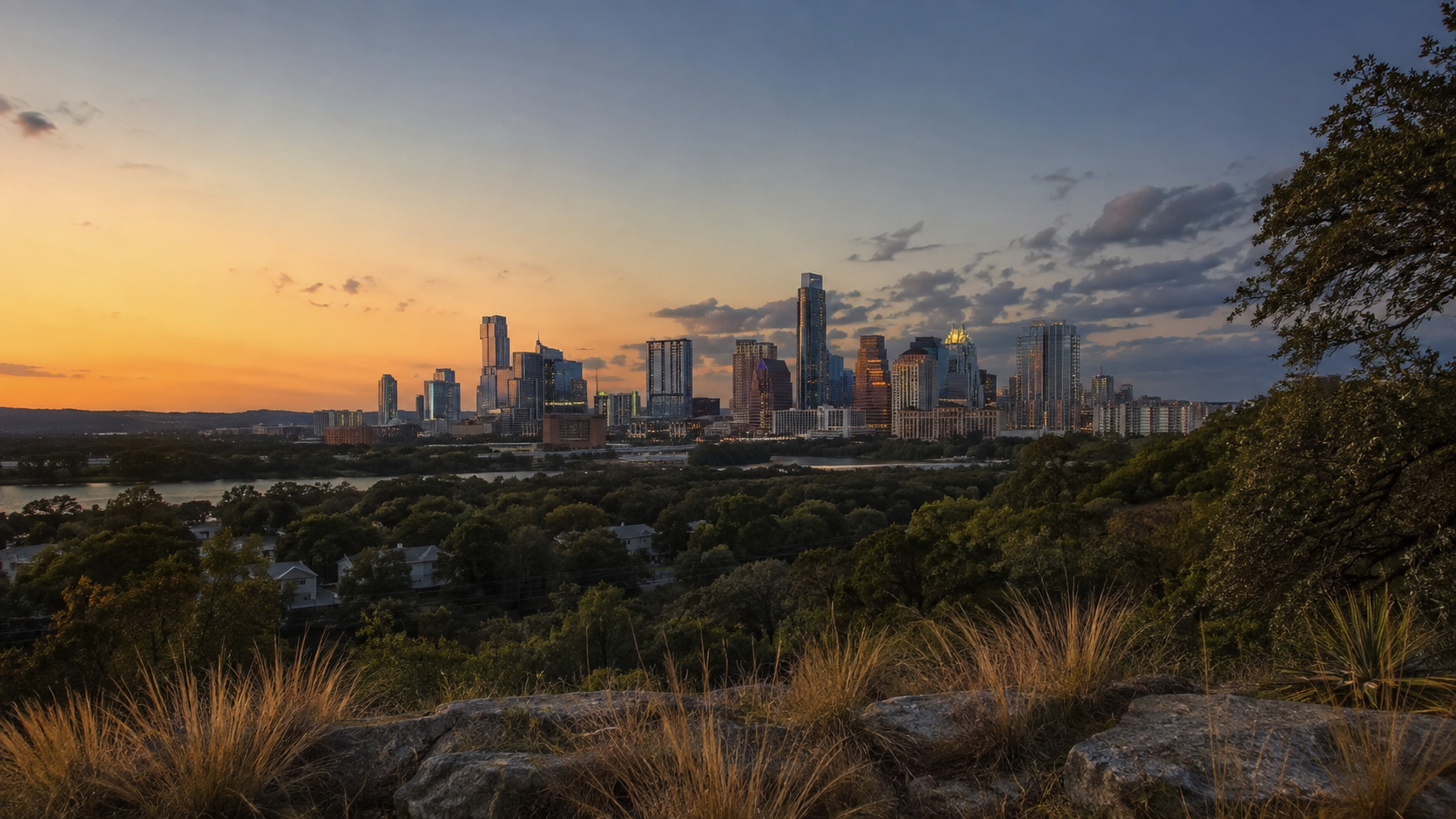 Austin skyline at sunset framed by native Texas landscape